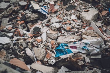 Waste plastic bottles and other types of waste at the ground.