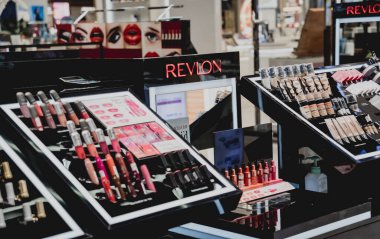 PHUKET, THAILAND - MAY 29, 2022: A rows of Revlon brand lipsticks in a case on the supermarket showcase.