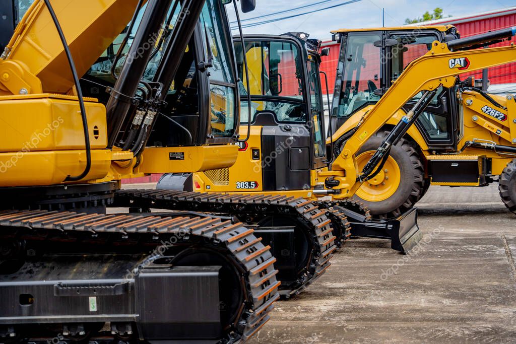 PHUKET, TAHAILAND - JUNE 05, 2022: Caterpillar heavy duty equipment vehicle on display area of dealership.