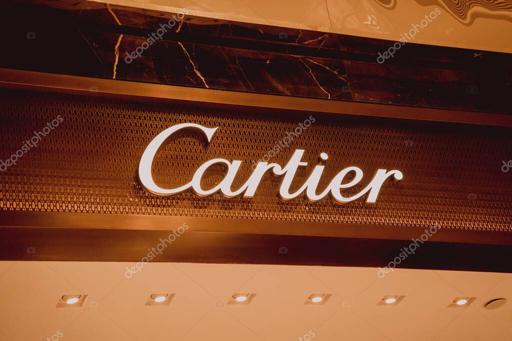 PHUKET, THAILAND - MAY 29, 2022: Cartier brand retail shop logo signboard on the storefront in the shopping mall.