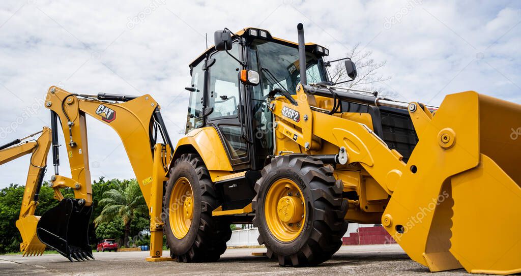 PHUKET, TAHAILAND - JUNE 05, 2022: Caterpillar heavy duty equipment vehicle on display area of dealership.