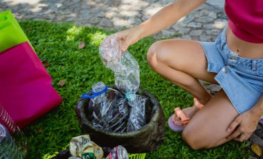 Genç güzel kız çöpleri özel kutulara ayırıyor..