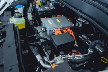 Electric vehicle with open hood and details of electric car engine.
