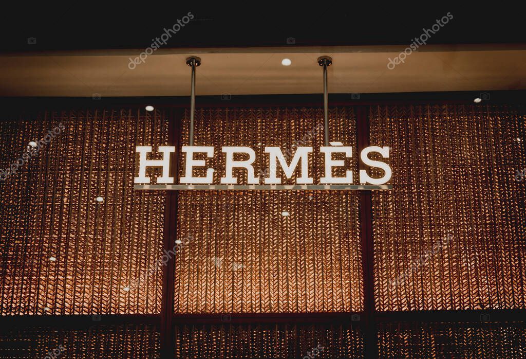 PHUKET, THAILAND - MAY 29, 2022: Hermes brand retail shop logo signboard on the storefront in the shopping mall.