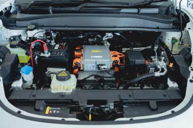 Electric vehicle with open hood and details of electric car engine.