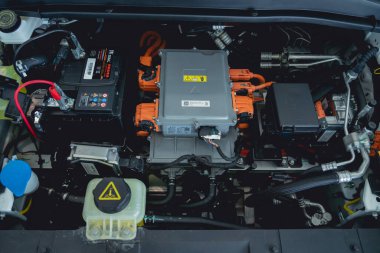 Electric vehicle with open hood and details of electric car engine.