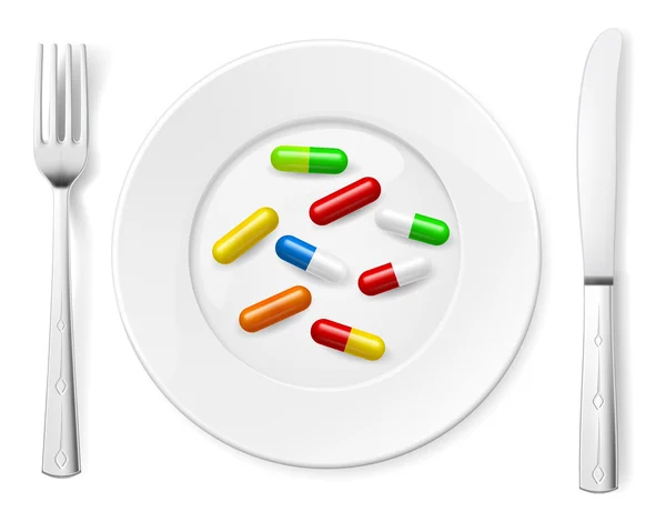 Medical pills on white plate with knife and spoon — Stock Photo, Image