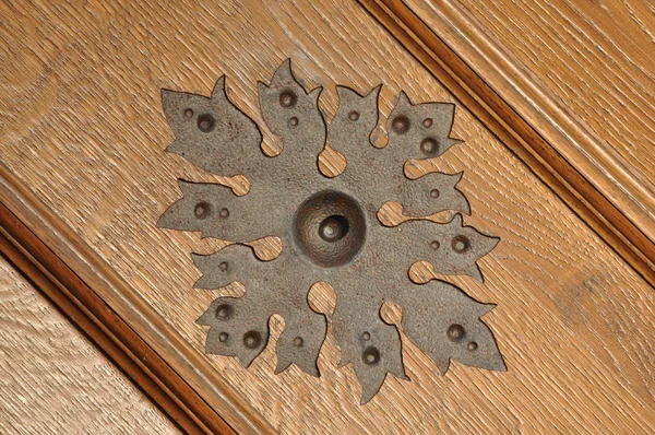 Steel ornament on wooden door — Stock Photo, Image