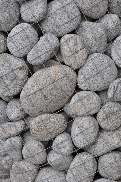 Round stones in a steel container — Stock Photo, Image