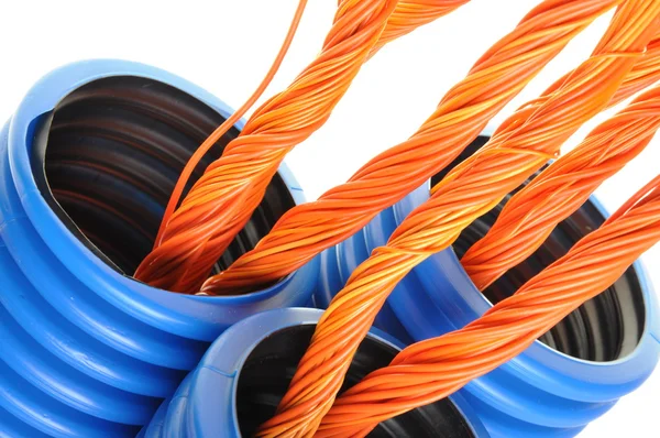 Blue corrugated pipe with orange cables — Stock Photo, Image