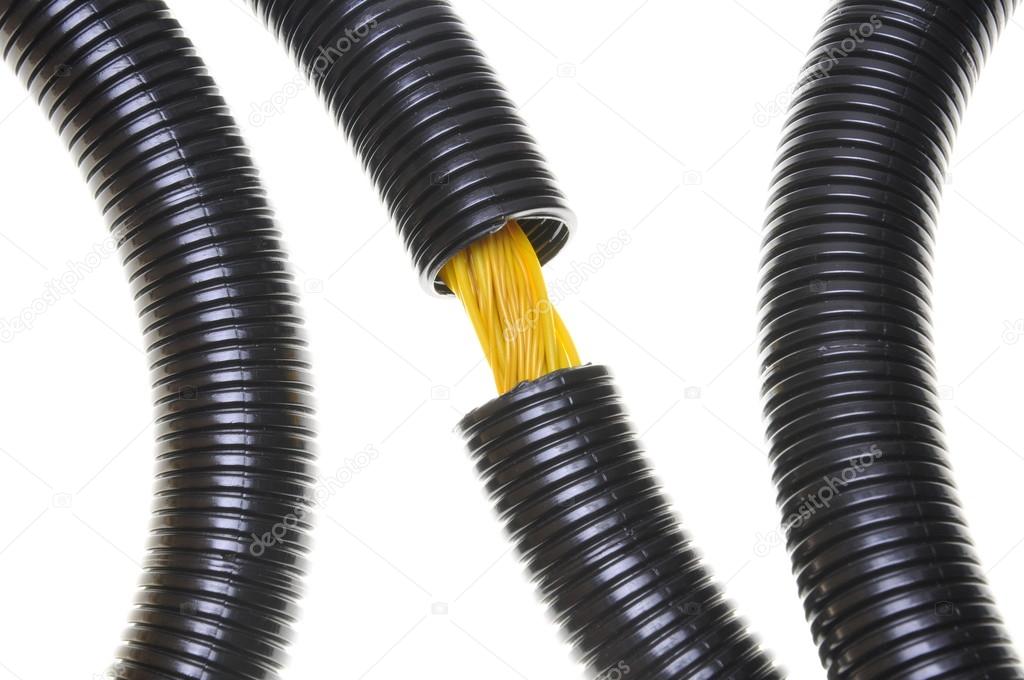 Corrugated black pipe with yellow cables