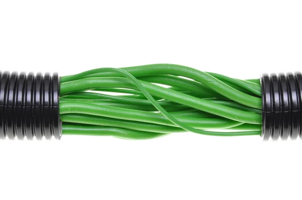 Corrugated black pipe with green cables — Stock Photo, Image