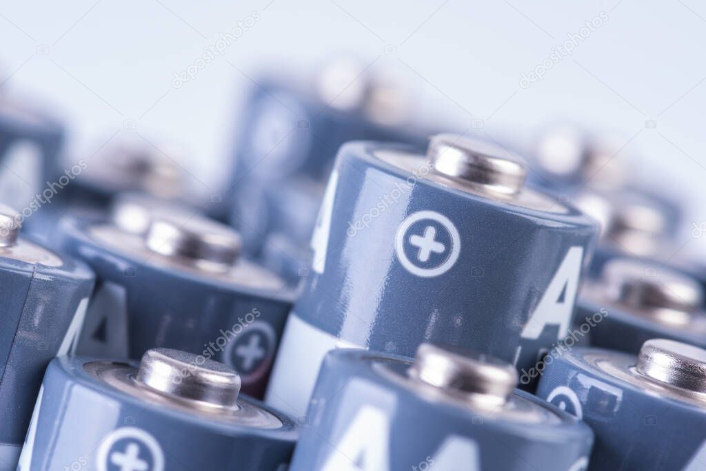 Close up set of alkaline battery size AA with focus on positive sign of one of them