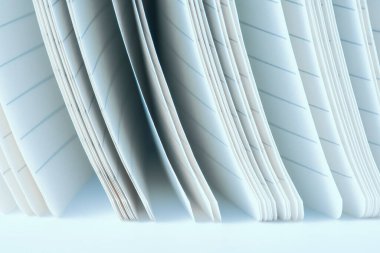 Edges of pages, opened lined notebook close-up