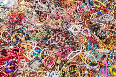 Colorful bracelets, beads, accessories and souvenirs on street market