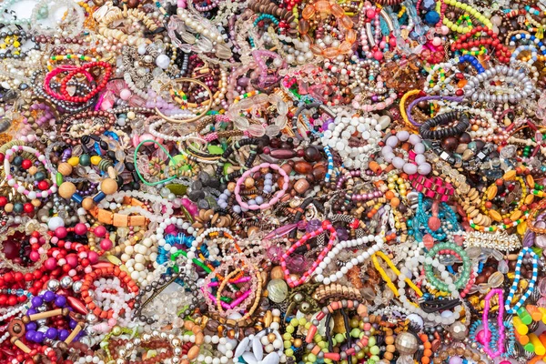 Colorful bracelets, beads, accessories and souvenirs on street market