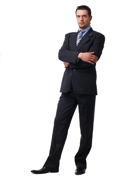 Empresário confiante em pé com as mãos dobradas . — Fotografia de Stock