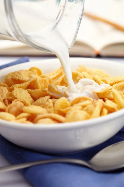 Milch über Cornflakes gießen — Stockfoto