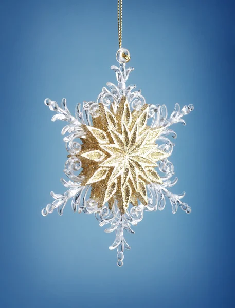 Glass snowflake on blue background — Stock Photo, Image