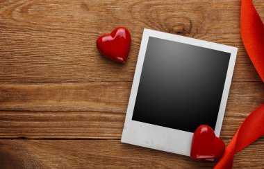 fotoğraf çerçevesi ve eski ahşap zemin üzerinde küçük kırmızı Kalpler