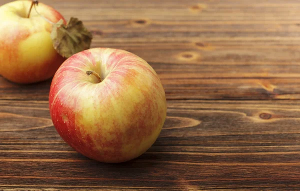 Czerwone jabłka na drewnianym stole — Zdjęcie stockowe