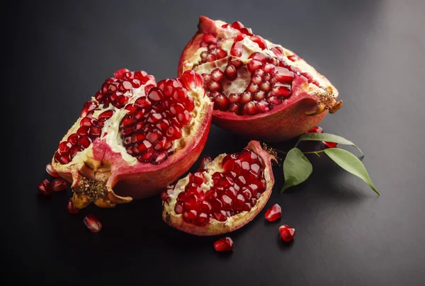 Piece of pomegranate on black background — Stock Photo, Image