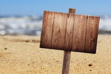 Wooden signboard on tropical beach