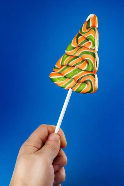 Hand holding lollipop — Stock Photo, Image