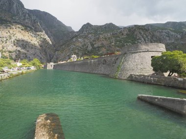 Kotor is a city in Montenegro, located on the limestone cliffs of Mount Lovcen on the Adriatic coast. In the medieval Old Town, surrounded by a fortress wall, many squares, winding streets and several Romanesque churches