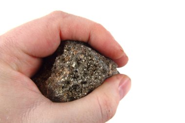 golden mineral in human hand