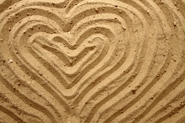 Текстура желтого песка (сердце ) — стоковое фото