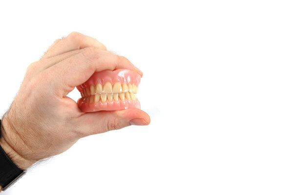 teeth prosthesis in human hand
