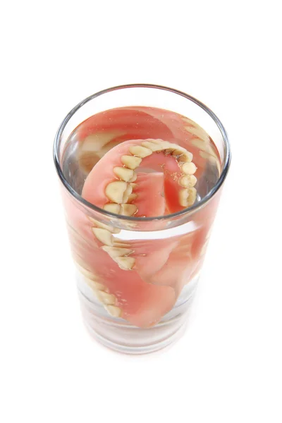 Teeth prosthesis in the glass — Stock Photo, Image
