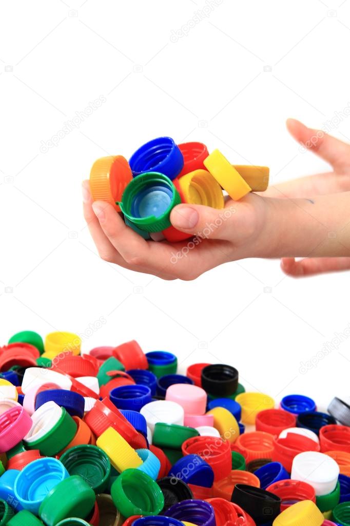 color plastic caps in human hands