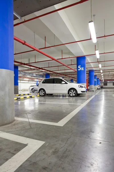 Парковка, подземный интерьер с несколькими припаркованными машинами — стоковое фото