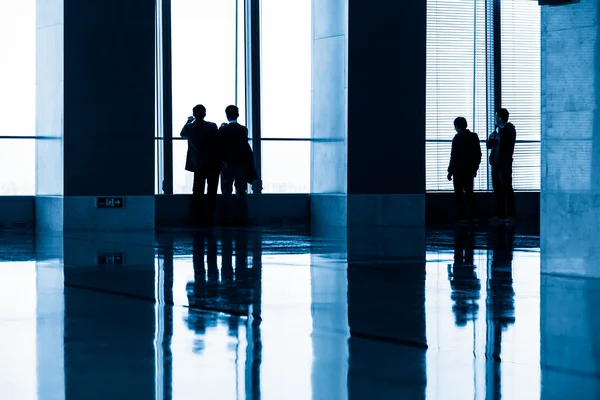 Image of silhouettes at morden office building — Stock Photo, Image