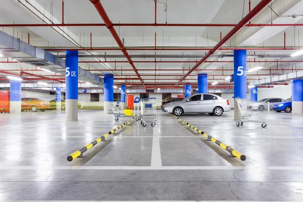 Parking garage, underground interior with a few parked cars — Stock Photo, Image