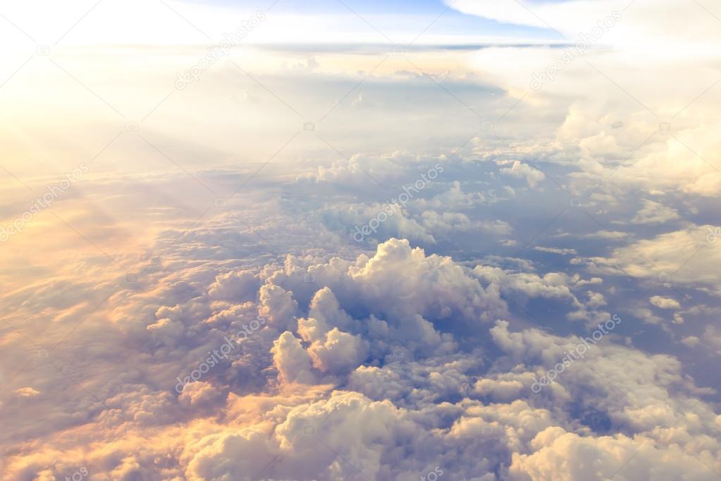 Clouds and sky as seen through window of an aircraft