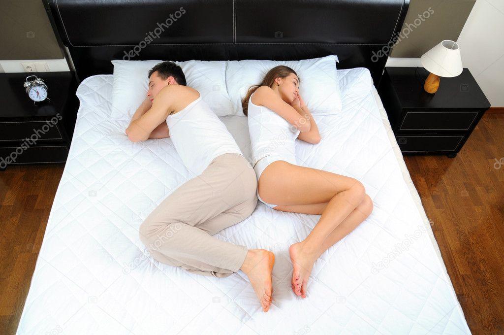 Upset pair of lovers lying on the bed. Family conflict