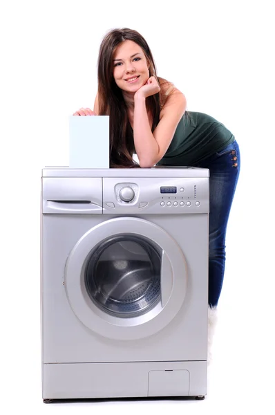 Woman with washing powder posing next to washing machine — Stock Photo, Image