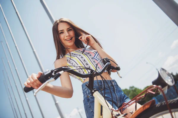 軽薄美しさ 自転車カメラ目線と笑顔を持つ若い茶髪女性 — ストック写真
