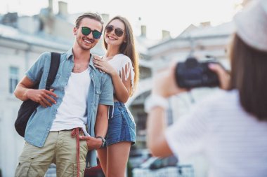 Arkadaşlık, eğlence ve insanlar kavramı. Arkadan görünüş genç kadının fotoğraf photocamera, açık havada, arkadaşlarıyla şehirde alıyor.