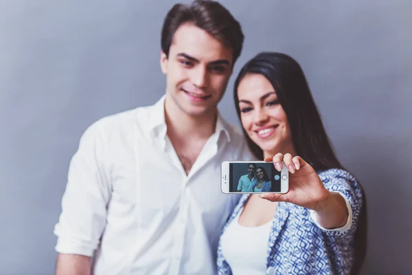 Genç Güzel Çift Kendini Yaparken Gülümse Kamera Gri Bir Arka — Stok fotoğraf