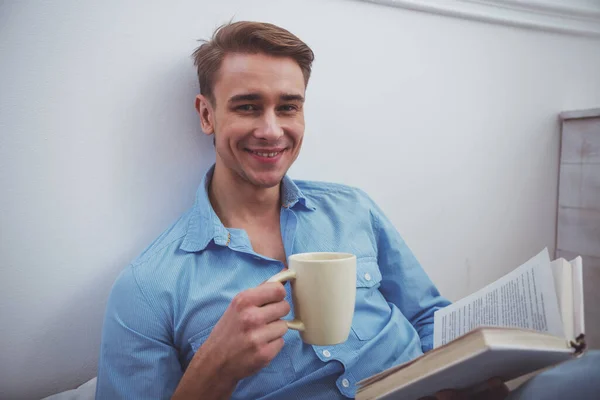 Young Handsome Man Blue Shirt Jeans Reading Book Cup His — Stock Photo, Image