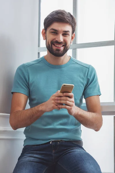 Handsome Man Casual Clothes Using Mobile Phone Looking Camera Smiling — Stock Photo, Image