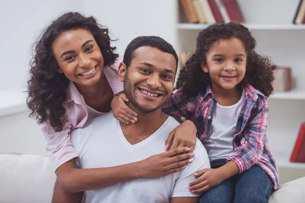 Linda Niña Afroamericana Sus Hermosos Padres Jóvenes Abrazándose Mirando Cámara —  Fotos de Stock