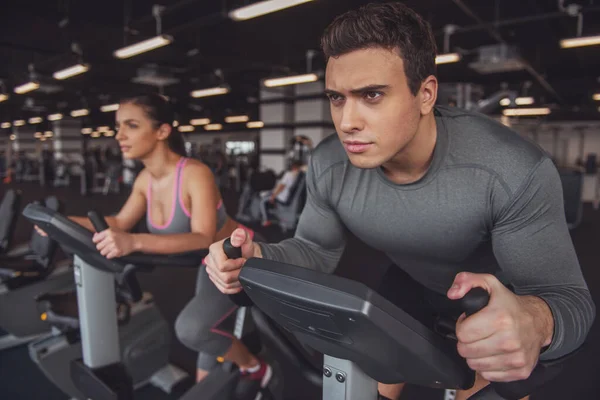 Attractive Young Muscular People Working Out Exercise Bike Gym — Stock Photo, Image