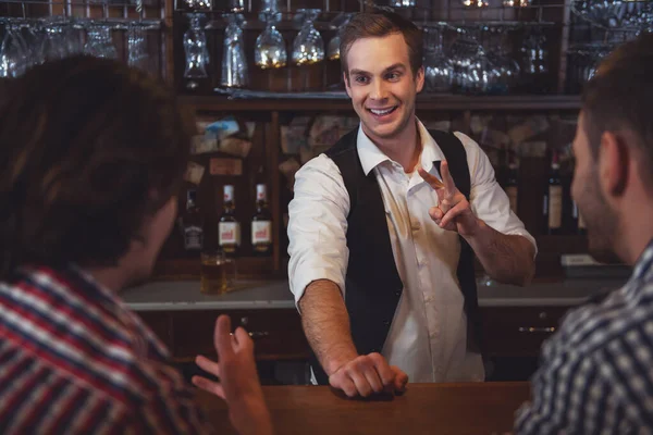 Attractive Bartender Smiling Taking Order Two Men Sitting Bar Counter — Stock Photo, Image