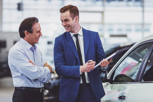 Jovem Bonito Terno Azul Clássico Está Sorrindo Mostrar Carro Para — Fotografia de Stock