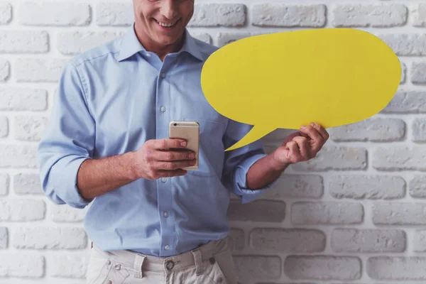 Handsome Middle Aged Man Holding Yellow Speech Bubble Using Smart — Stock Photo, Image